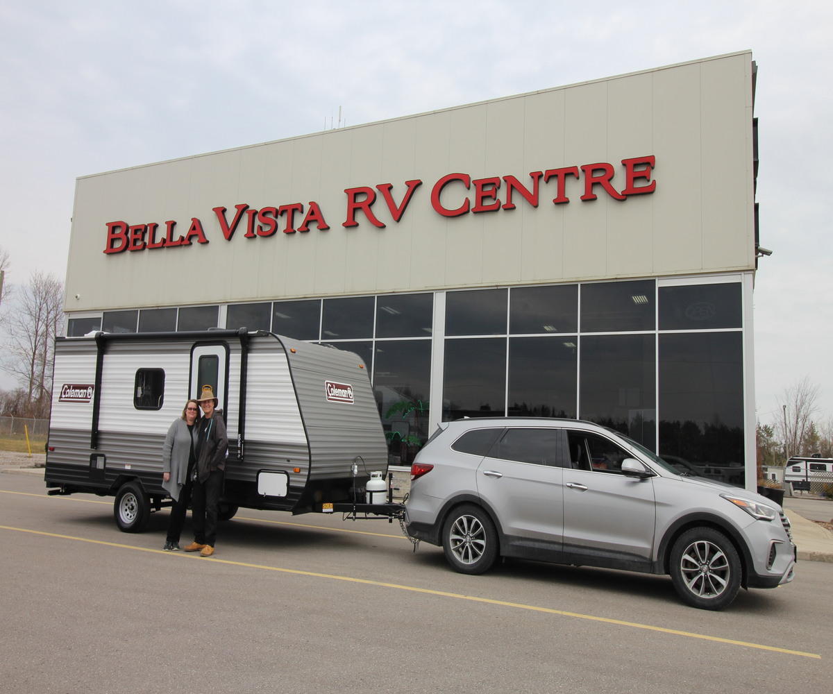 A happy couple picks up a Coleman RV